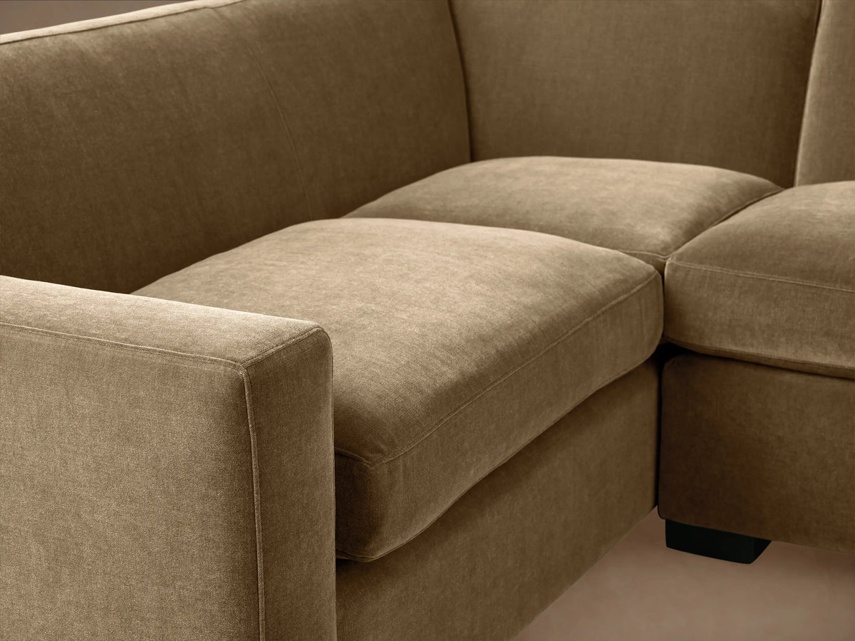 Bronte Two-Piece Sectional in plush muted olive green, L-shaped, on wood floor against a light wall.