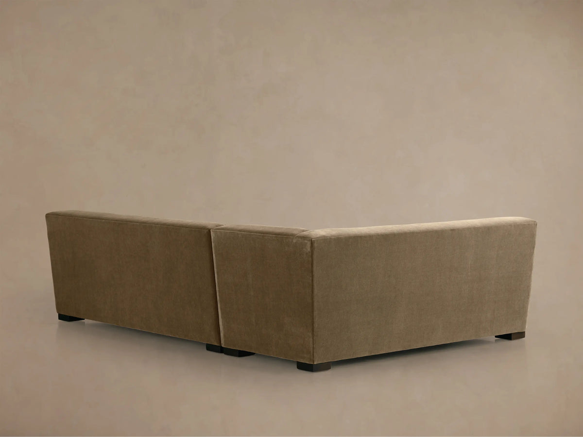 Close-up of Bronte Two-Piece Sectional's corner in a soft, textured warm brown fabric, showing armrest & plush seat cushions.