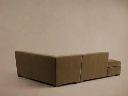Elevated, partial view of the olive Bronte Two-Piece Bumper Chaise Sectional, highlighting the soft, deep cushions and chaise lounge.