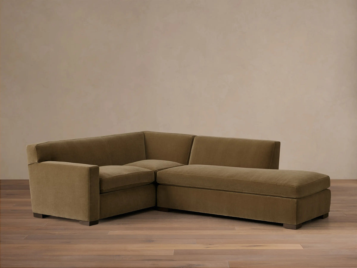 Front view of an olive green Bronte Two-Piece Bumper Chaise Sectional, showing its L-shaped design and clean lines.