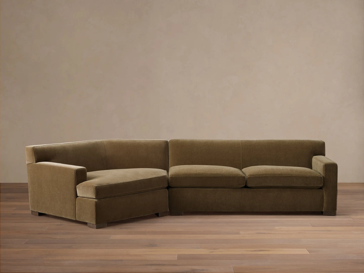 Front view of the olive green velvet Bronte Two-Piece Cuddle Chaise Sectional, featuring a left-arm chaise.