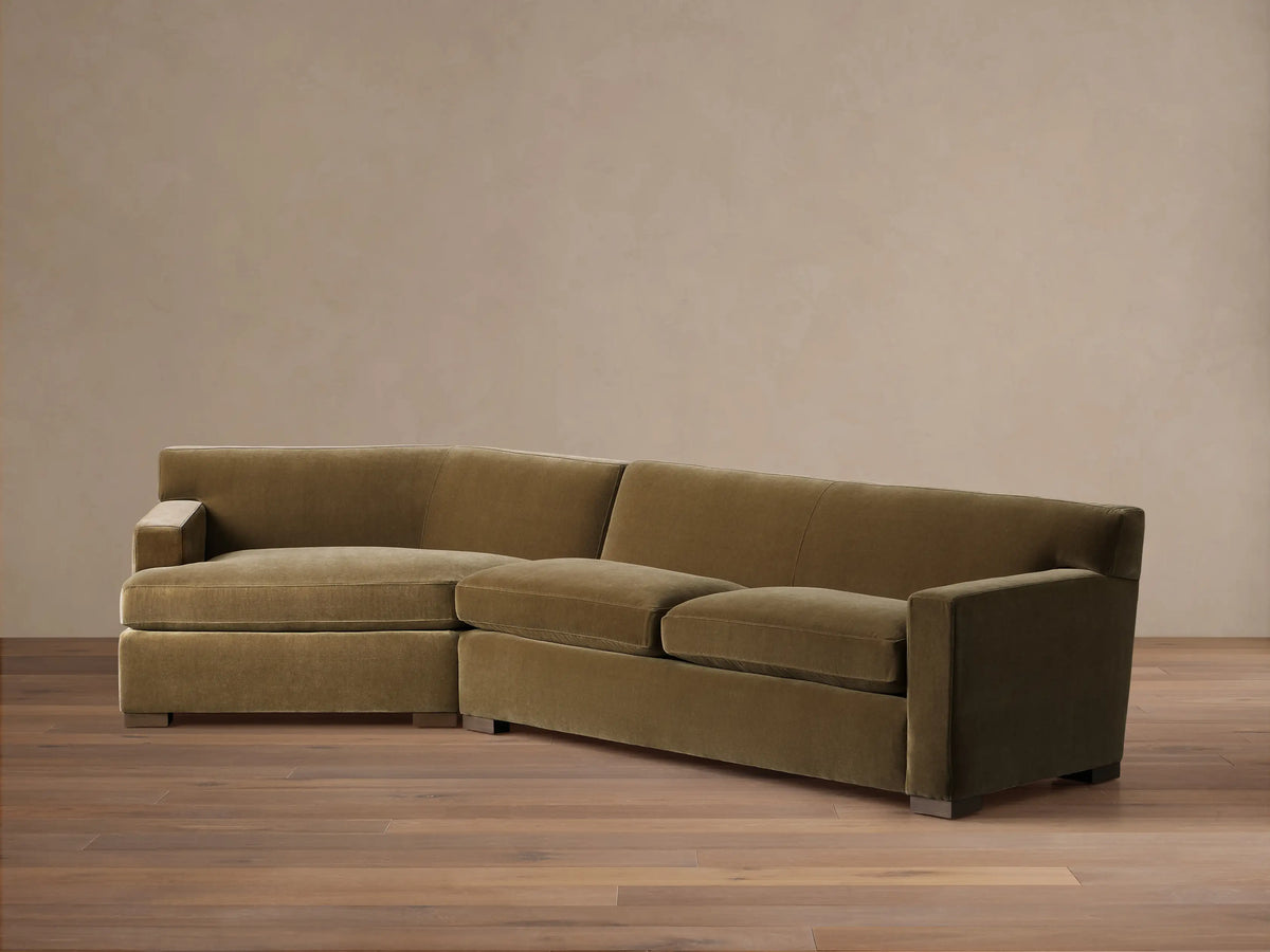 Front view of the olive green velvet Bronte Two-Piece Cuddle Chaise Sectional, featuring a left-arm chaise.