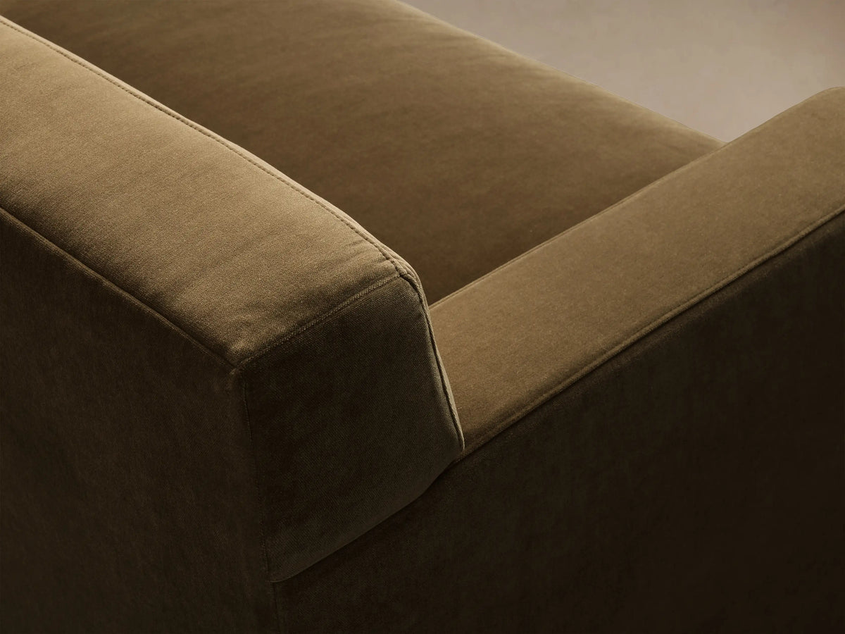 Close-up of the olive green Bronte Bench-Seat Sofa, showing the textured fabric on the armrest and seat cushion.