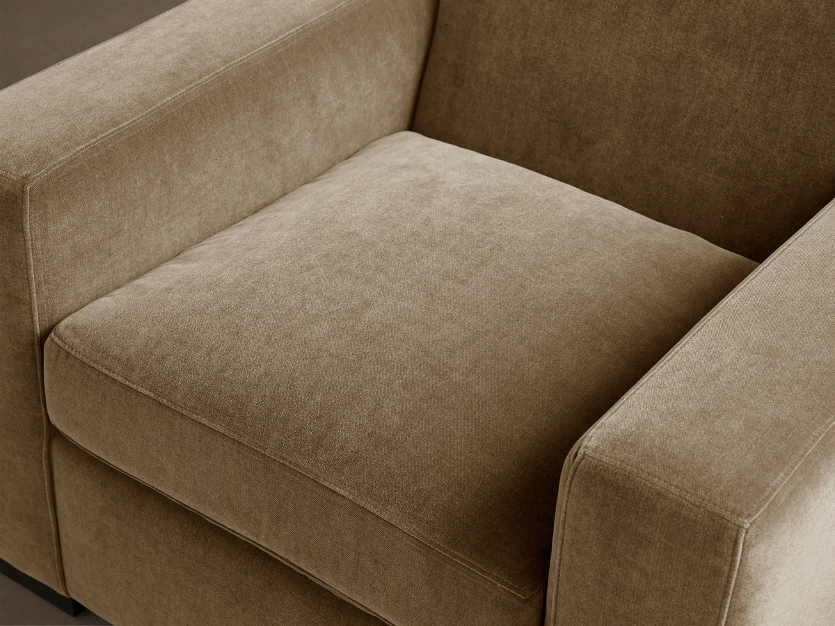 Bronte Chair, modern, boxy armchair, upholstered in soft, textured tan fabric, with square arms and plush seat cushion.