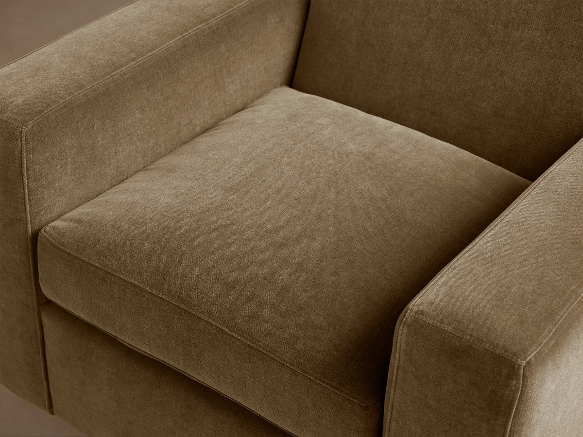 Bronte Swivel Chair, side view. Plush, rectangular olive-brown velvet-like fabric. Smooth, flat arms.
