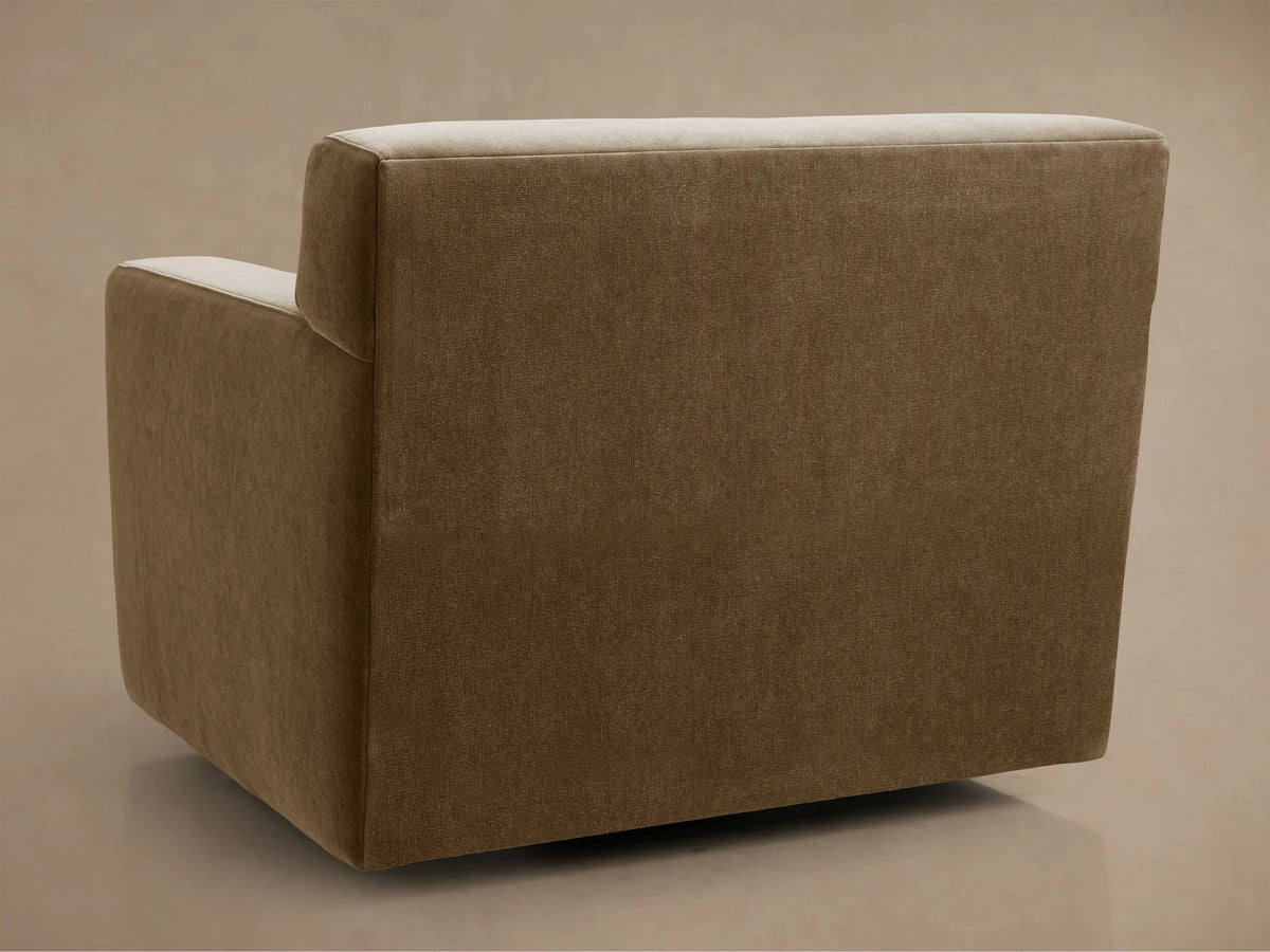 Close-up of the Bronte Swivel Chair, showing its textured neutral brown fabric seat cushion and square armrests from above.