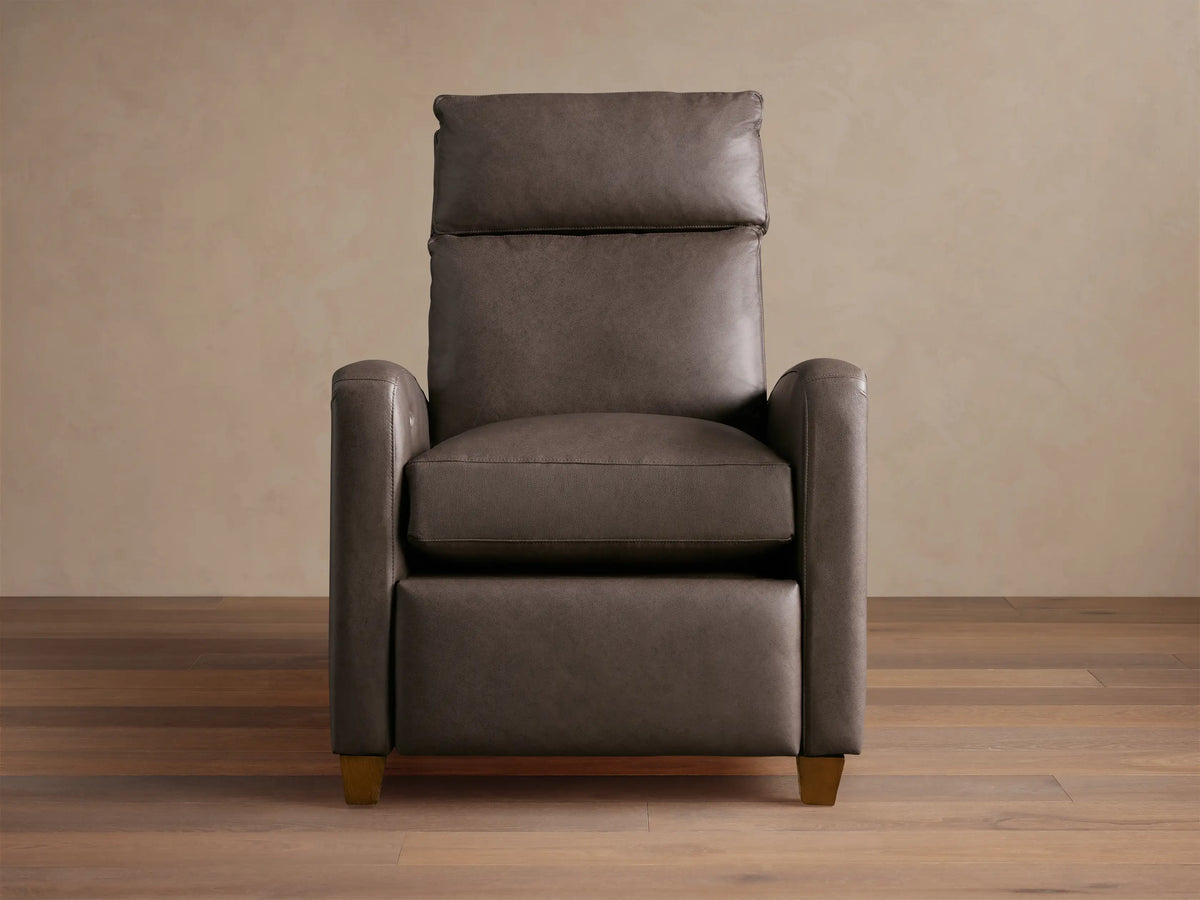 Colfax Leather Motion Recliner, dark taupe leather, upright, with comfortable padded headrest & wood feet, on wood floor.