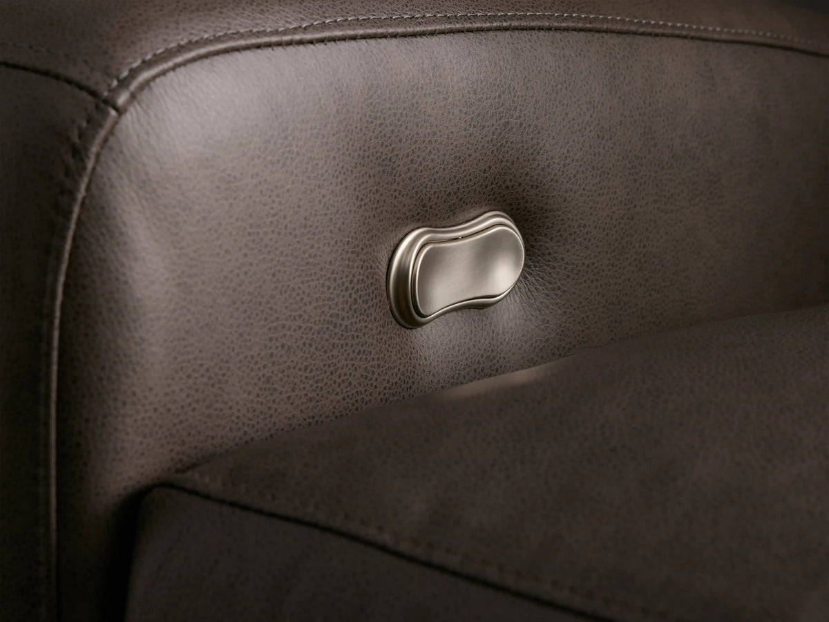 Close-up, high-angle of the dark grey pebbled Colfax Leather Motion Recliner, partially reclined with elevated footrest.