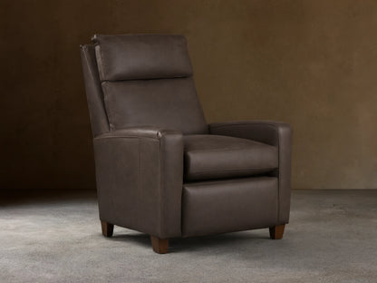 Colfax Leather Motion Recliner, dark taupe leather, upright, with comfortable padded headrest & wood feet, on wood floor.