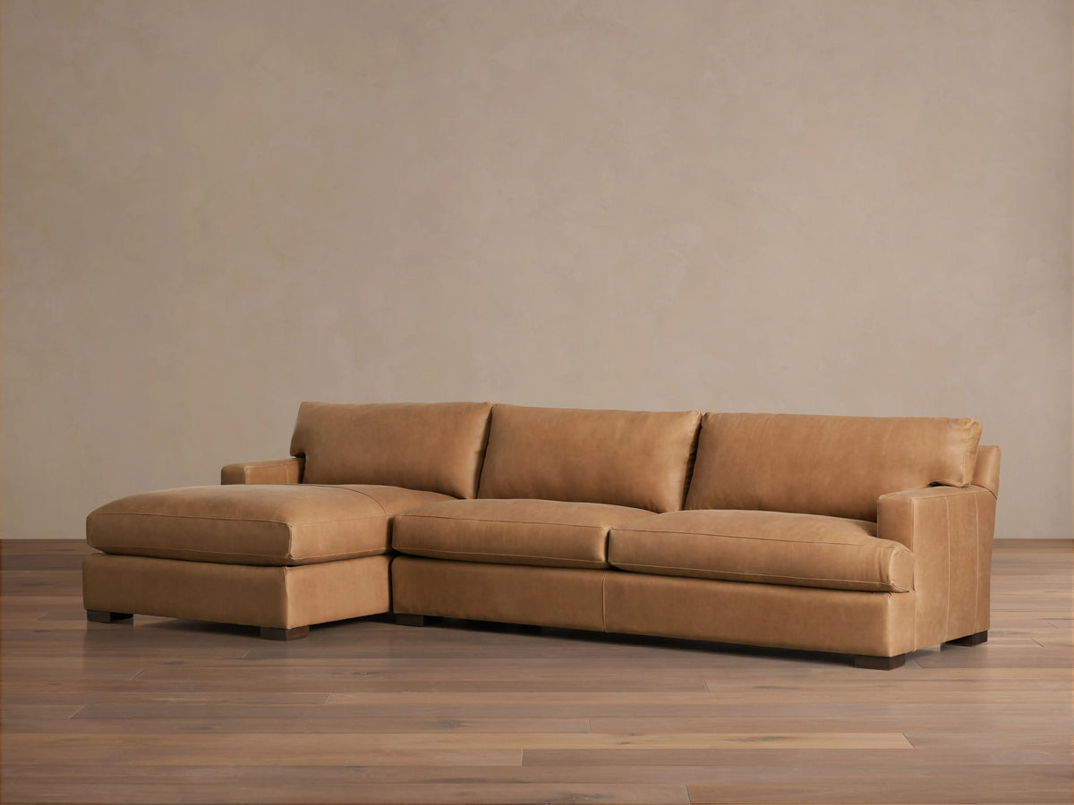 Dune Leather Two Piece Chaise Sectional in brown leather, rear view. Features sleek design with straight lines and plush cushions.