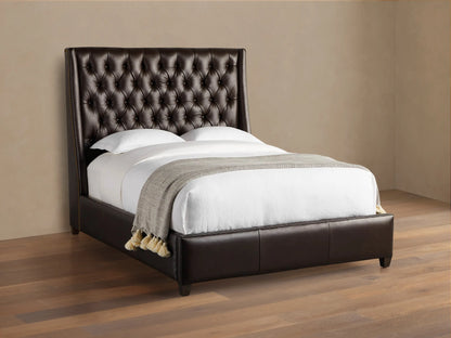 Devereaux Leather Tufted Bed in dark brown leather with a deeply tufted headboard, white bedding, and gray throw on wood floor.