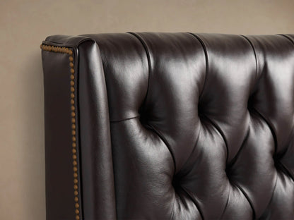 Devereaux Leather Tufted Bed, dark brown, with a high, diamond-tufted headboard and matching base. White bedding, gray throw.