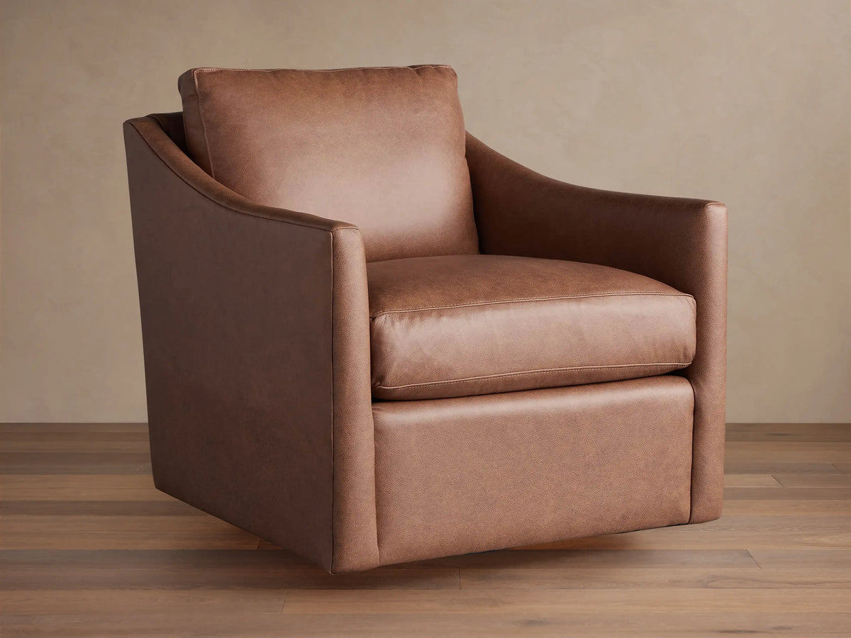 Branson Leather Swivel Chair, rich brown, angled slightly right. Plush seat & back cushions, wide arms on wood floor.
