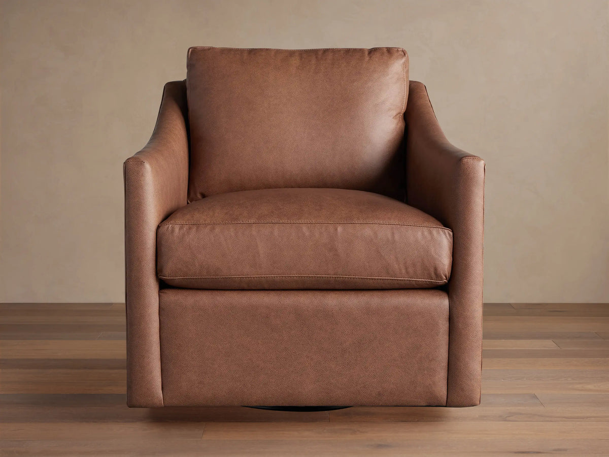 Branson Leather Swivel Chair, rich brown, angled slightly right. Plush seat & back cushions, wide arms on wood floor.