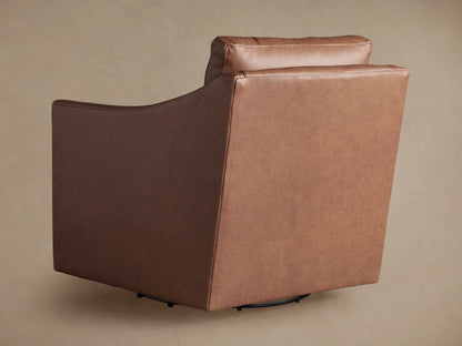 Close-up of Branson Leather Swivel Chair, textured brown leather armrest, seat, and back cushion with stitching details.