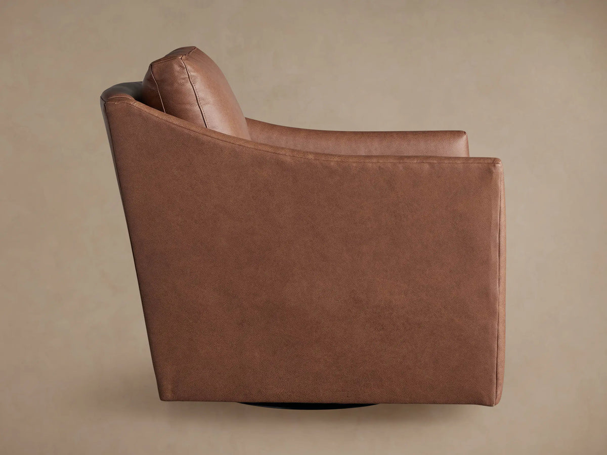 Branson Leather Swivel Chair, back-right view. Upholstered in rich caramel brown leather with a padded back and black swivel base.