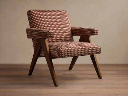 Front view of the brown and beige upholstered Elias Chair, with a geometric checkerboard pattern, and dark wood exposed arms and tapered legs.