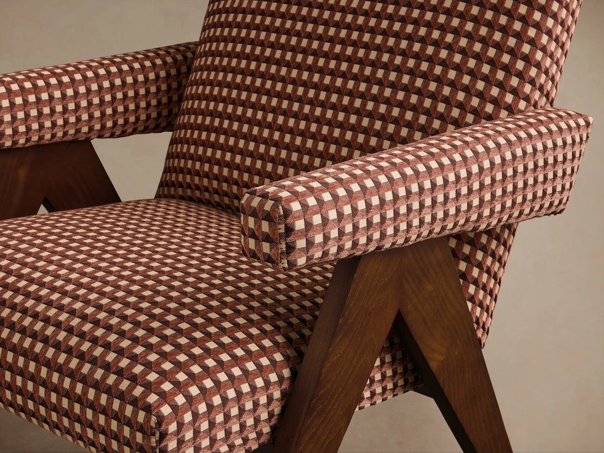 Front view of the Red and cream geometric pattern Elias Chair with dark wooden legs.