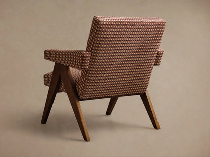 Angled view of Elias Chair with brown, cream, and reddish-brown geometric checkerboard upholstery and dark wooden frame.