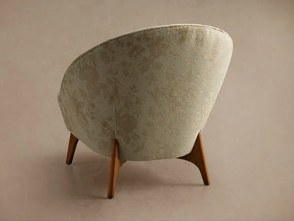 Close-up of the beige Elodie Chair, featuring a raised floral pattern in a darker beige hue.