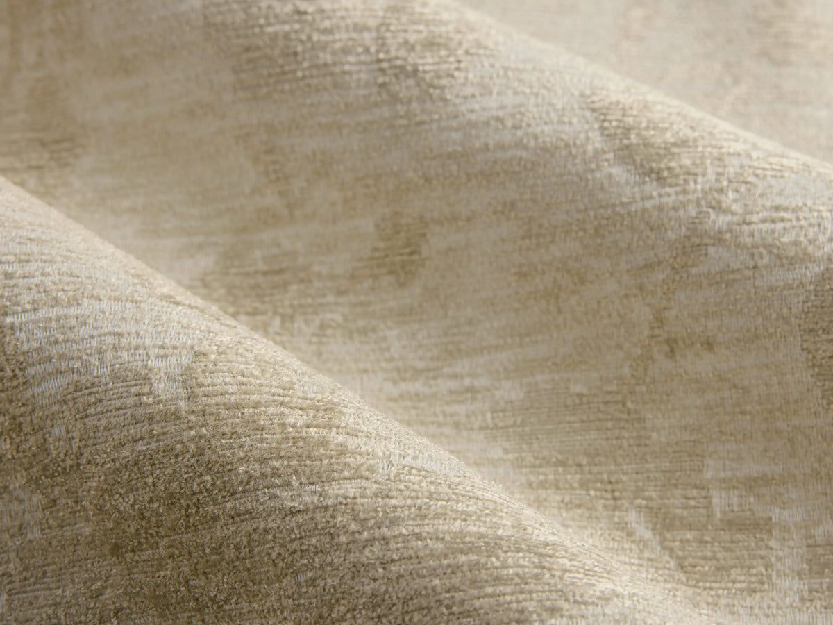 Rear view of a pale green Elodie Chair upholstered with a beige floral pattern, featuring splayed wooden legs.