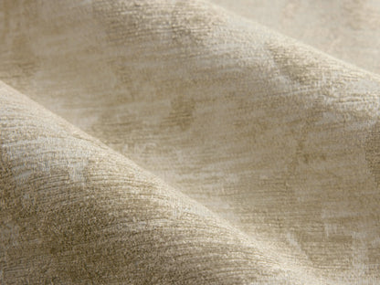 Rear view of a pale green Elodie Chair upholstered with a beige floral pattern, featuring splayed wooden legs.