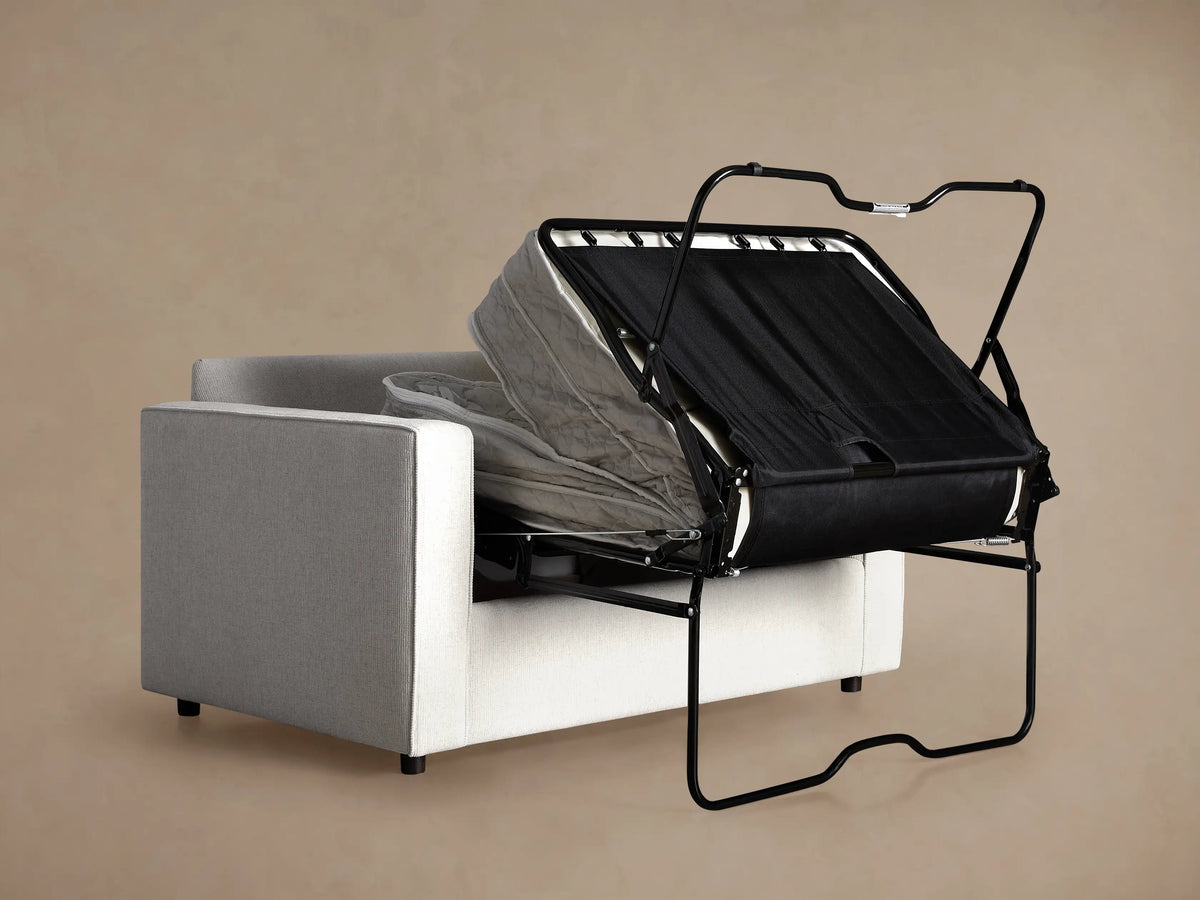 Close-up of Filmore Twin Air Sleeper Chair, featuring its light, finely textured fabric on the armrest, seat, and back cushions.