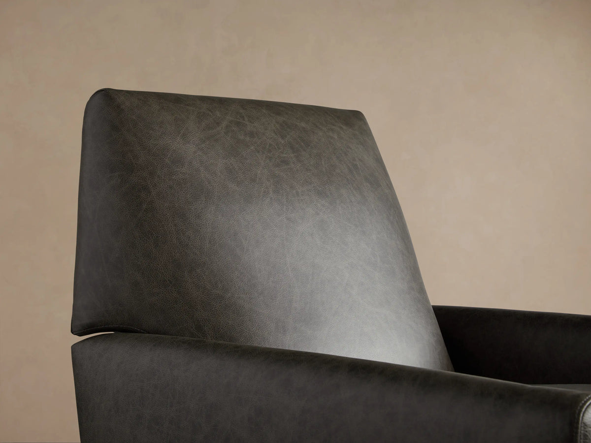 Harvey Leather Swivel Recliner, front. Distressed dark gray leather with natural texture, padded seat, back & arms, black swivel base.