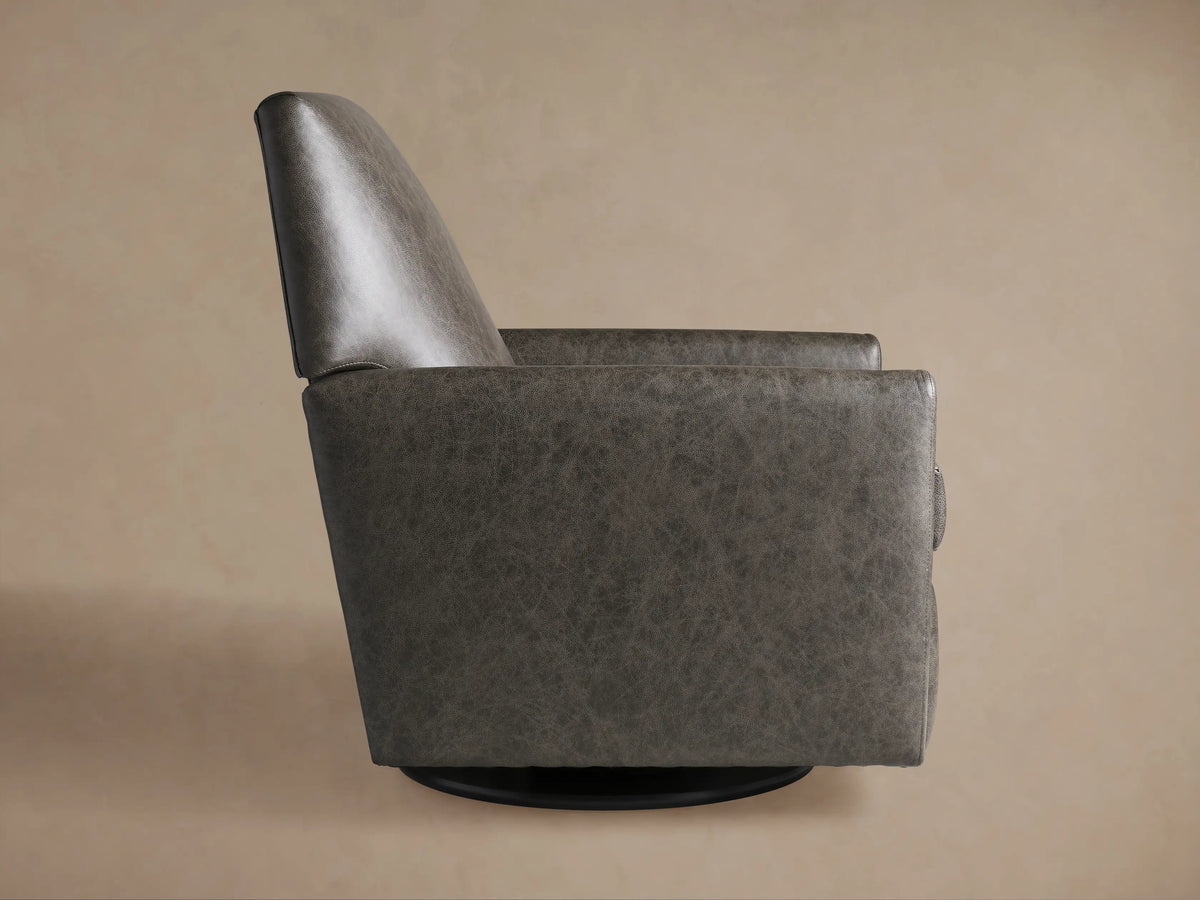 Grey textured Harvey Leather Swivel Recliner, seen from the back-left, featuring a high back, square arms, and black swivel base.