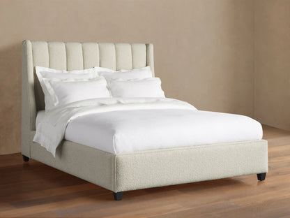 Hayworth Bed: Light beige textured upholstery, channel-tufted headboard, white bedding, dark feet, on wood floor.
