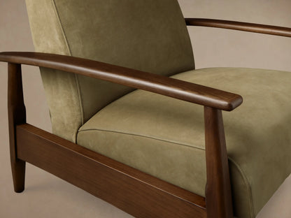 Close-up view of an olive green upholstered chair with dark brown wooden armrests and legs, featuring subtle stitching.