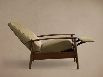 Front view of a sage green upholstered armchair with a horizontal back seam, dark wood armrests, and tapered legs.
