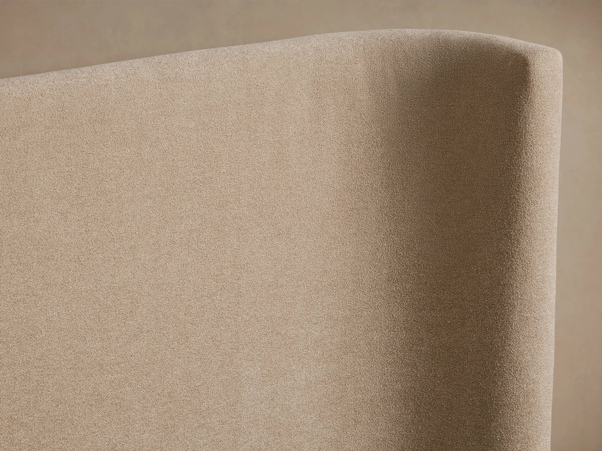 Hathaway Extended Bed with a beige upholstered winged headboard and matching frame, featuring white pillows and quilted bedding.