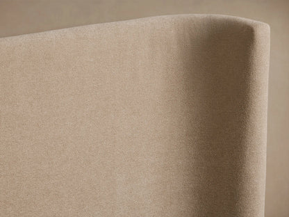 Hathaway Extended Bed with a beige upholstered winged headboard and matching frame, featuring white pillows and quilted bedding.