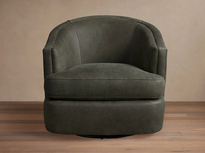 Kieran Leather Swivel Chair in dark gray, featuring a curved back, round seat, and smooth finish on wooden floor.
