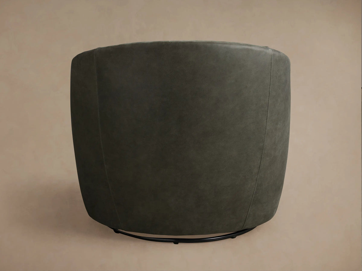 Kieran Leather Swivel Chair in dark grey leather, viewed from the back, showing its curved design and smooth, textured surface.