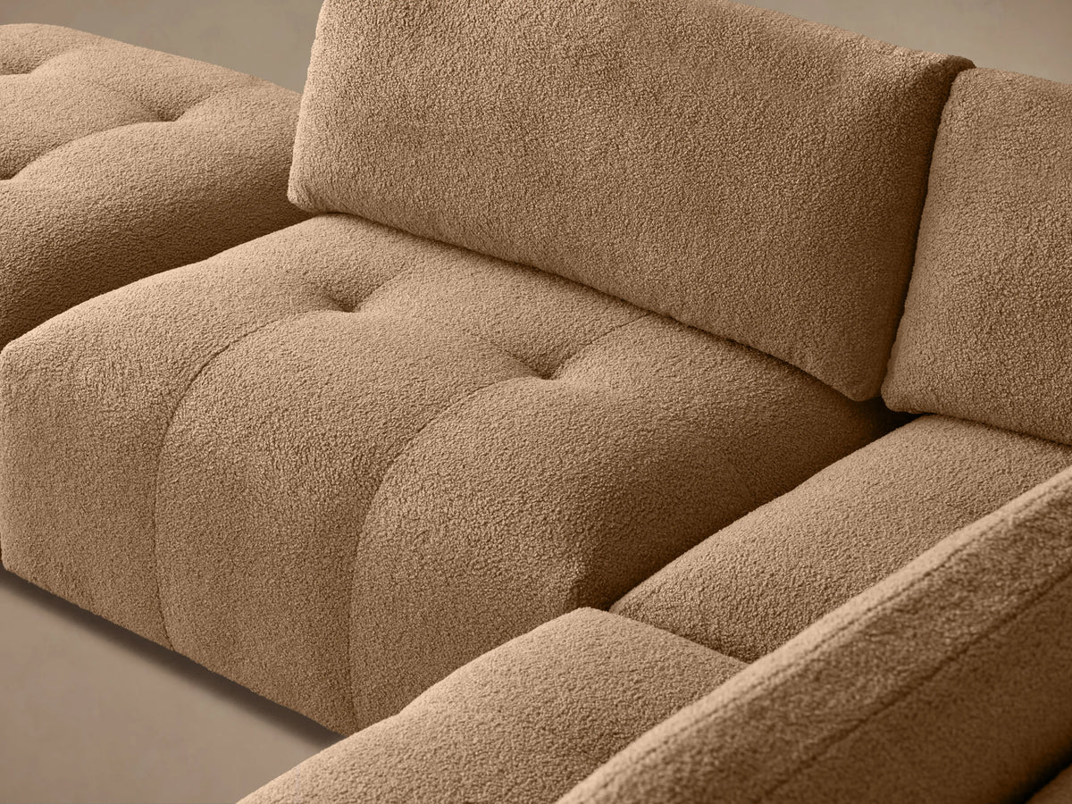 Tan, five-piece "Keegan" sectional with plush cushions in an L-shape on wooden floor. Right side armrest, sleek modern design.
