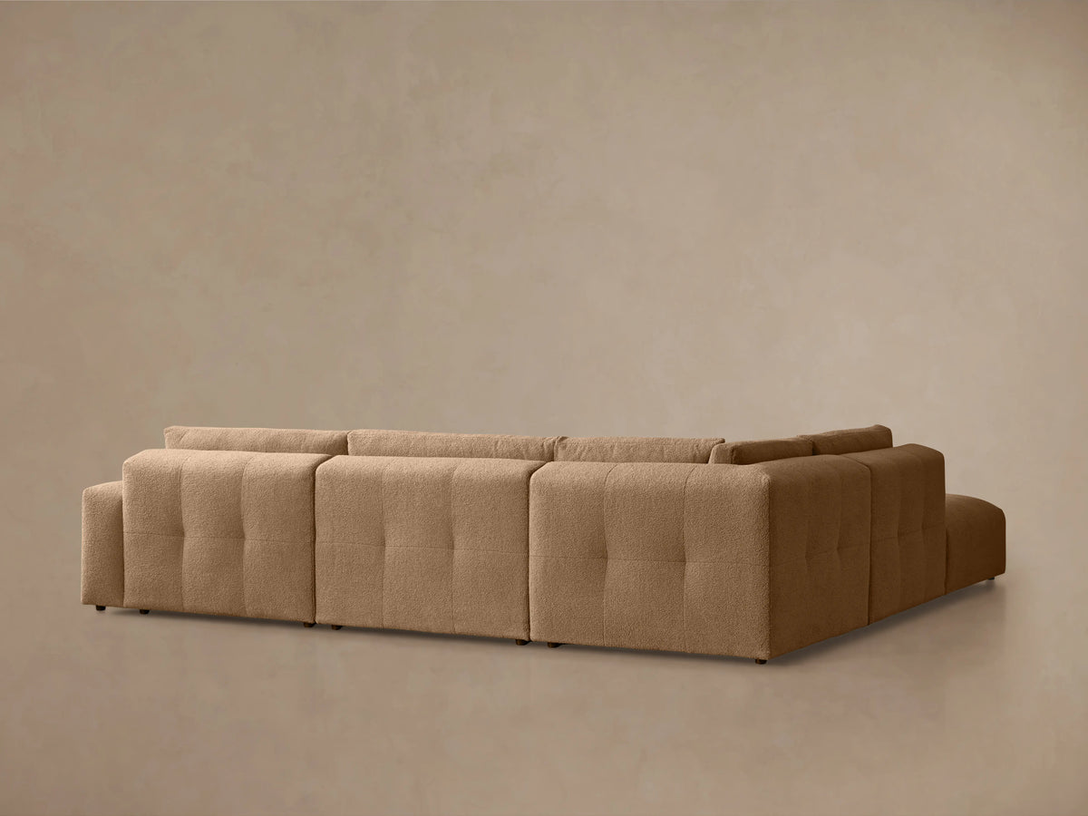 Keegan Five-Piece Sectional in textured, light brown fabric. Features tufted seat and back cushions with a modular design, viewed from above.