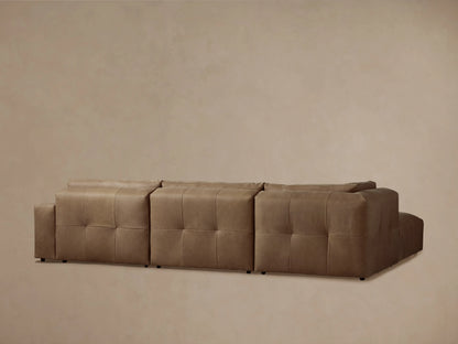 Keegan Leather Four-Piece Sectional in brown leather, showcasing tufted seat detail and smooth back cushions in close-up view.
