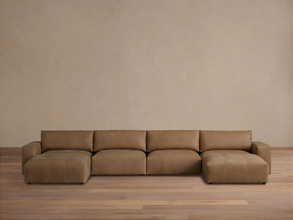 Brown leather Keegan six-piece sectional on wooden floor against beige wall, featuring clean lines and plush cushions.