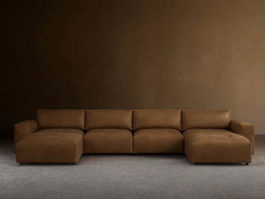 Brown leather Keegan six-piece sectional on wooden floor against beige wall, featuring clean lines and plush cushions.