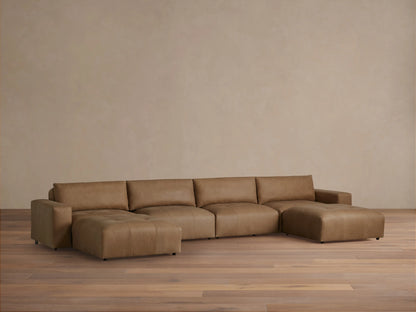 Brown leather Keegan six-piece sectional on wooden floor against beige wall, featuring clean lines and plush cushions.