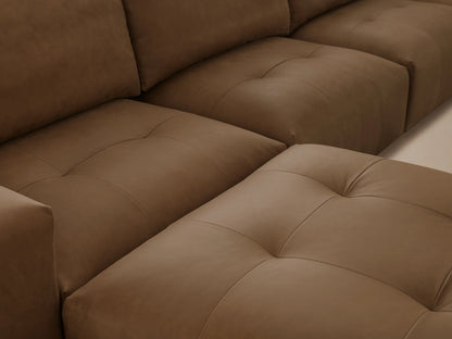 Keegan Leather Six-Piece Sectional in tan leather, L-shaped with plush backrests and deep seats on wooden floor against beige wall.