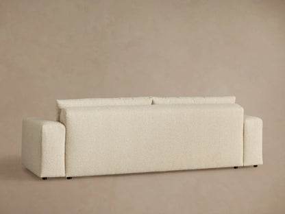 Close-up of Keegan Tailored Sofa in light, textured oatmeal fabric, showing structured back cushions and matching seat.