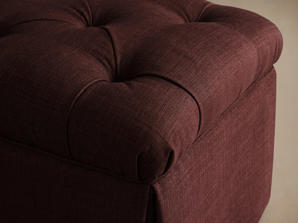 Top view of a burgundy Liddie Square Ottoman, showing the tufted top with button details.