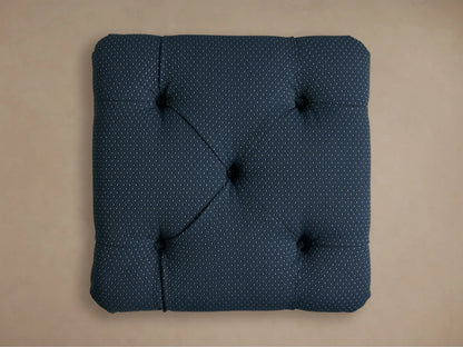 Close-up of the deep blue-green dotted fabric on the Liddie Square Ottoman, showing a tufted detail.
