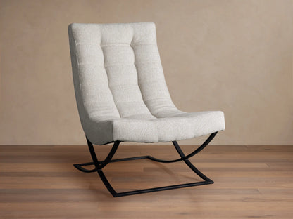 Lloyd Chair: Modern light grey fabric chair with a tall, padded back and seat, on a unique black metal X-frame base, angled on wood floor.
