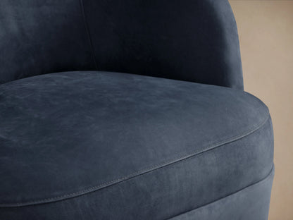 Front view of Mercer Nubuck Leather Swivel Chair. Dark blue, velvety nubuck leather, curved back, plump seat on wood floor.