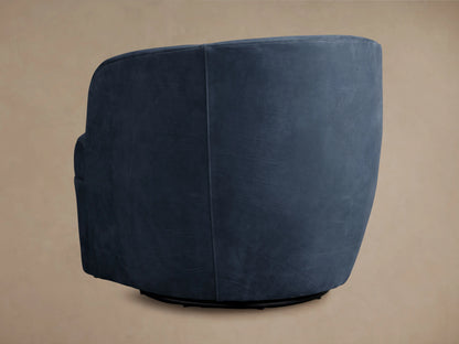 Close-up of a navy blue Mercer Nubuck Leather Swivel Chair, highlighting its velvet-like texture and detailed seat stitching.