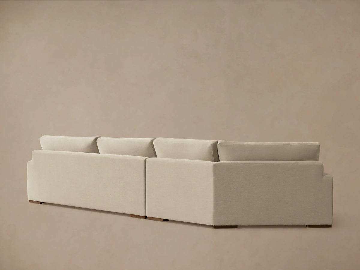 Beige Norwalk Two-Piece Cuddle Chaise Sectional with plush seat and back cushions, featuring a modern, clean-lined design.
